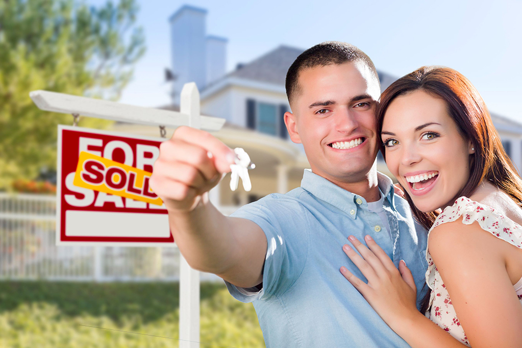 Military couple in front of new house